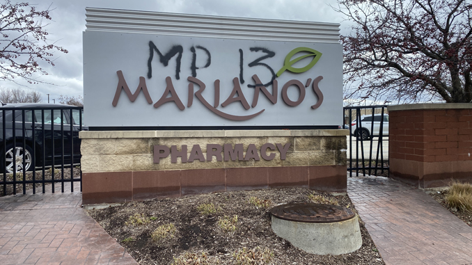 Graffiti at Mariano's sign at the southwest corner of Kensington Road and Dryden Place