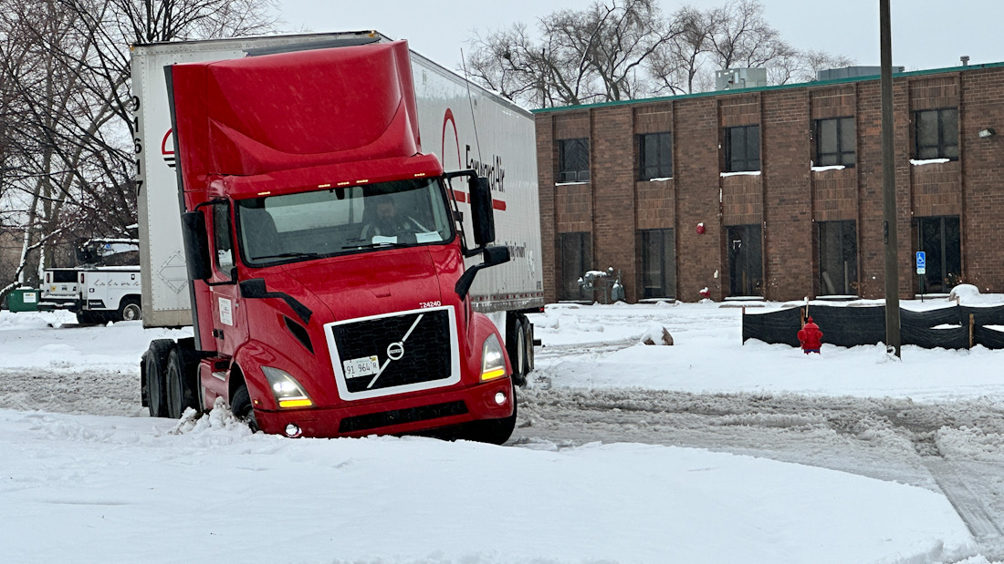 A semi-trailer truck gut stuck in snow off King Street south of Lee Street and sits blocking King Street in Elk Grove Village at about 12:54 p.m. Friday, January 12, 2024 (CARDINAL NEWS)