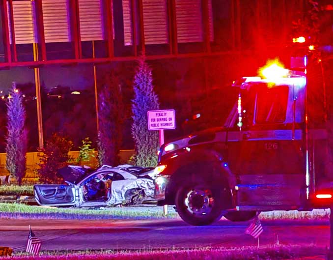 Wrecked Mitsubishi with an Arlington Heights Fire Department ambulance in the foreground between Route 53 and Wilke Road just after 1:00 a.m. Saturday, May 25, 2024 (photo provided 
 to CARDINAL NEWS)