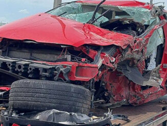 Red Ford Focus with severe driver's side damage after a crash with a tandem trailer of a semi-trailer truck on Tuesday, June 4, 2024 (CARDINAL NEWS)