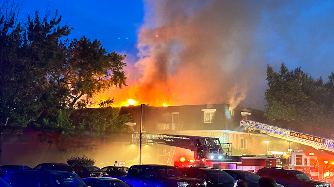 Fire through the roof at a three-story apartment building with a mansard roof on Palm Drive in Mount Prospect (CARDINAL NEWS)