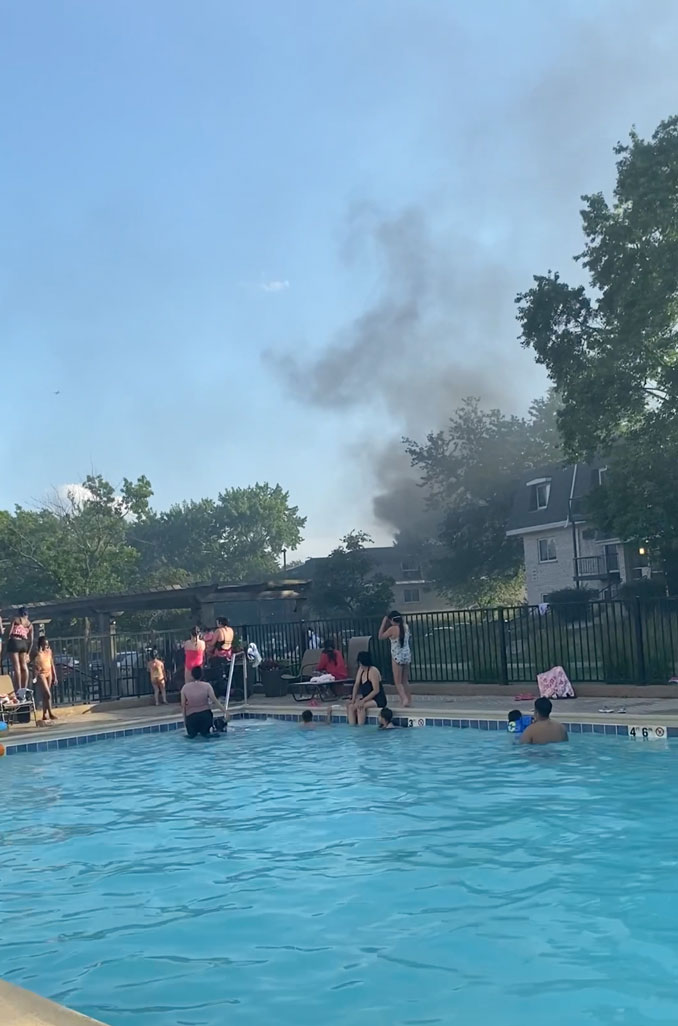 Early smoke showing at the beginning of the extra-alarm fire in Mount Prospect, visible from the apartment complex pool on Monday, June 17, 2024 (provided image).