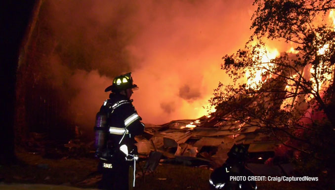 Firefighter standing in front of the a collapsed wall after a house explosion and fire on Overland Drive in Lake Zurich, Tuesday night, June 4, 2024 (Craig/CapturedNews)
