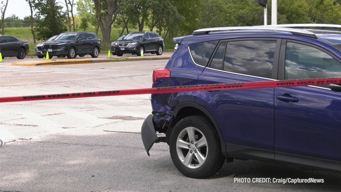 Blue Toyota RAV4 with passenger-side damage at the rear fender after a collision with a motorcycle on Lake Cook Road and Wilke Road in Arlington Heights (PHOTO CREDIT: Craig/CapturedNews)