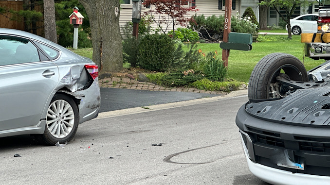 Hyundai Kona (right) rolled over after the driver hit the parked silver sedan on the left in this photo Tuesday afternoon July 9, 2024 (CARDINAL NEWS)