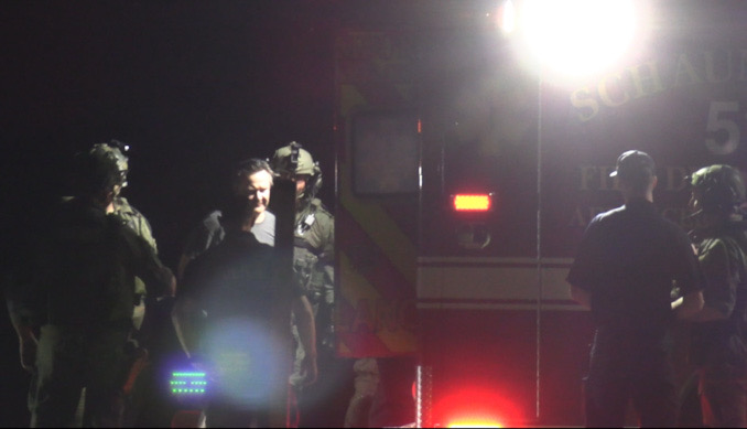 A male adult in handcuffs was transferred to a Schaumburg Fire Department ambulance after the standoff ended Wednesday night, July 24, 2024