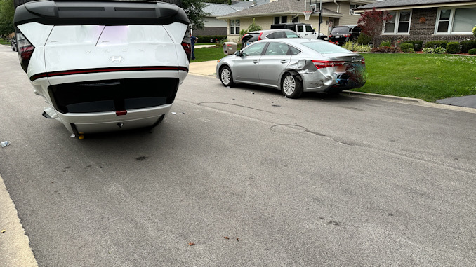 The driver of a white Hyundai Kona (left) traveling southbound on Belmont Avenue hit the parked silver sedan on the right in this photo Tuesday afternoon July 9, 2024 (CARDINAL NEWS)