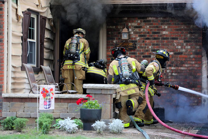 Firefighters working at extinguishing a fatal garage fire at house on Woodhollow Lane in Buffalo Grove on Monday, July 22, 2024 (PHOTO CREDIT: John J. Kleeman)