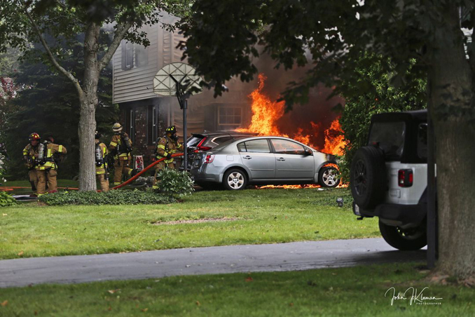 Flames showing at a fatal garage fire at house on Woodhollow Lane in Buffalo Grove on Monday, July 22, 2024 (PHOTO CREDIT: John J. Kleeman)