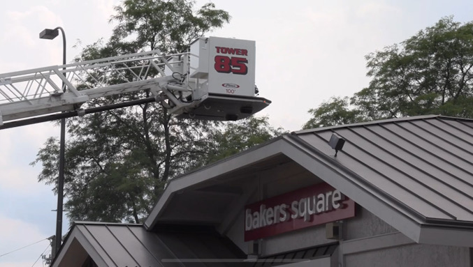 Palatine Tower Ladder 85 in a ready position in case of a larger extension of fire as firefighters put a stop to a fire near an exterior wall at ground level on the northeast area of the building on Monday, July 22, 2024 (CARDINAL NEWS)