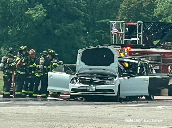 Firefighters working immediately after they extinguished a fire involving two crashed vehicles on Golf Road near Busse Woods in Rolling Meadows (PHOTO CREDIT: Scott Jamieson)