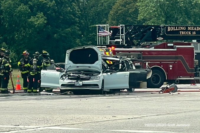 Firefighters working immediately after they extinguished a fire involving two crashed vehicles on Golf Road near Busse Woods in Rolling Meadows (PHOTO CREDIT: Scott Jamieson)