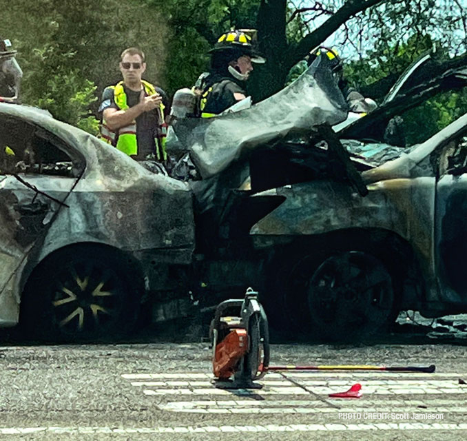 Firefighters working immediately after they extinguished a fire involving two crashed vehicles on Golf Road near Busse Woods in Rolling Meadows (PHOTO CREDIT: Scott Jamieson)