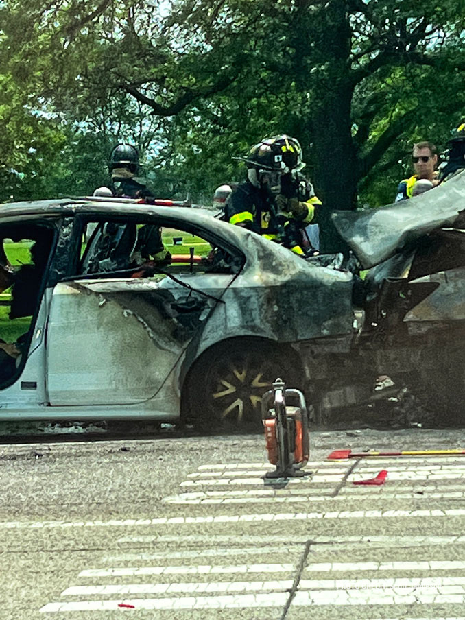 Firefighters working immediately after they extinguished a fire involving two crashed vehicles on Golf Road near Busse Woods in Rolling Meadows (PHOTO CREDIT: Scott Jamieson)