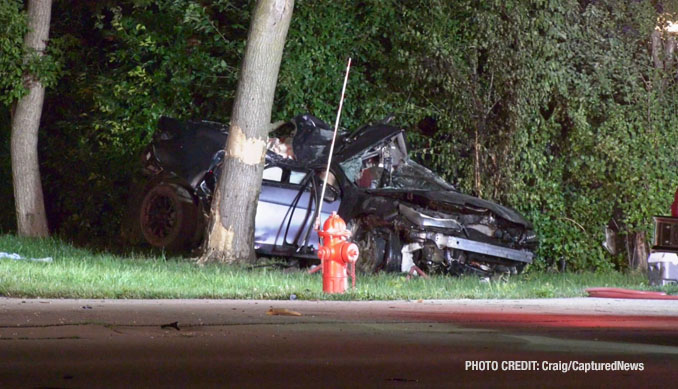 Destroyed vehicle and scar marks on a tree at the scene of a fatal crash on Grand Avenue near Prospect Drive in Lindenhurst (PHOTO CREDIT: Craig/CapturedNews)