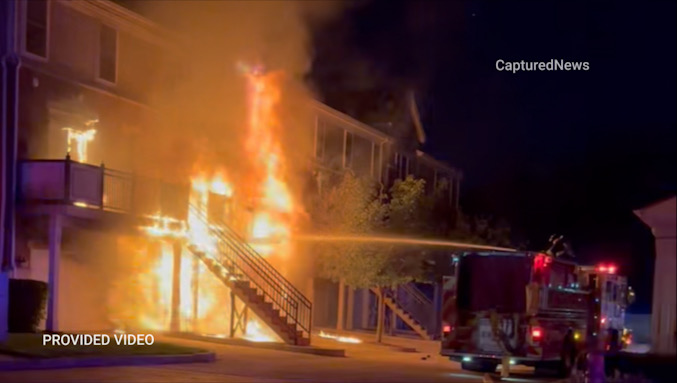 Firefighters from Engine 3 deploy a deck gun to knock down fire showing from a 3-story townhouse on Crambourne Way, Friday, August 9, 2024 around 9:00 p.m. (Provided Video/CapturedNews)