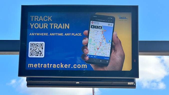 Message board (looking inbound to Chicago) at downtown Arlington Heights Metra train station frozen on train tracker display on September 30, 2024 (CARDINAL NEWS)