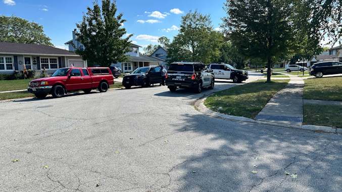 Police investigating the scene after a woman was apparently hit by her blue SUV in the driveway of her home in Elk Grove Estates subdivision in Elk Grove Village, Wednesday, September 25, 2024 (CARDINAL NEWS)