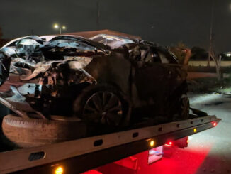 An Illinois State Police trooper rescued two dogs while this Buick was rolled on its passenger side and on fire at a commercial property near I-90 after it was rear-ended on I-90 by the driver of an Audi (CARDINAL NEWS)