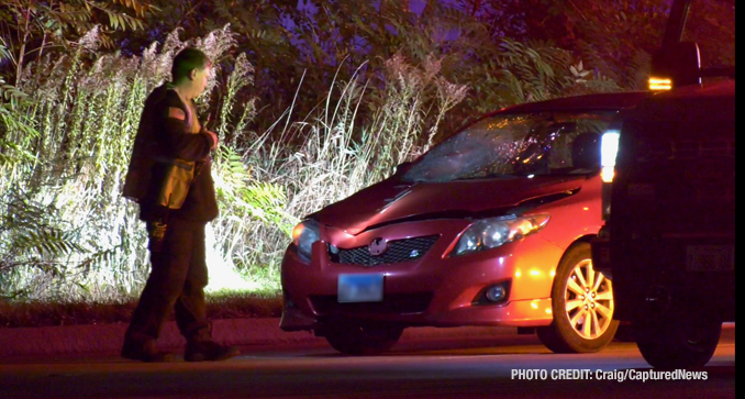 Windshield and front-end damage on the red 4-door sedan that remained at the scene after a fatal vehicle vs pedestrian crash on Friday night, October 18, 2024 (PHOTO CREDIT: Craig/CapturedNews)