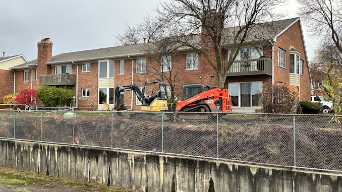 Excavators at the scene where an underground power line was hit during property maintenance at a condo townhouse neighborhood on Douglas Court in Arlington Heights (CARDINAL NEWS)